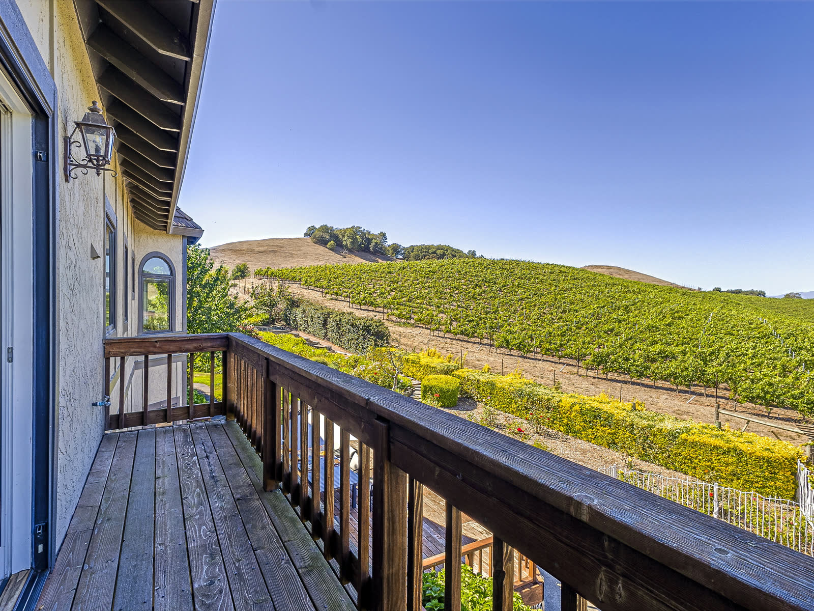 The primary suite balcony, looking down the vine rows