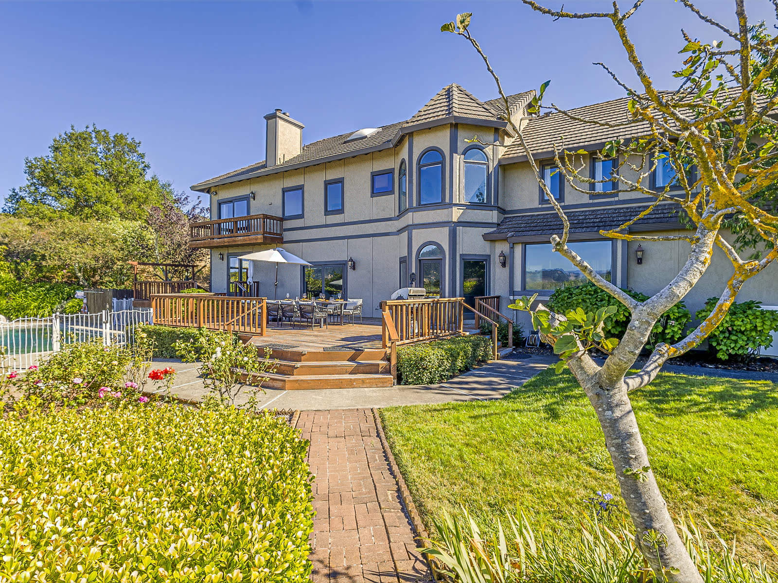 The house from the garden, with the deck and the pool below it